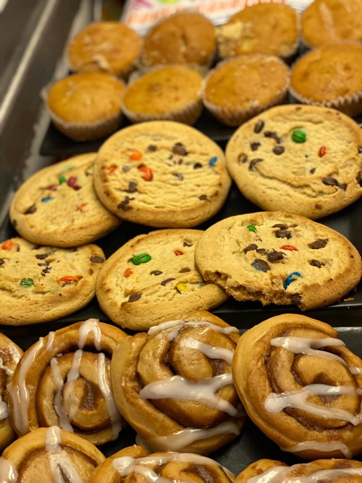 Fresh-baked M&M cookies, muffins, and iced cinnamon rolls